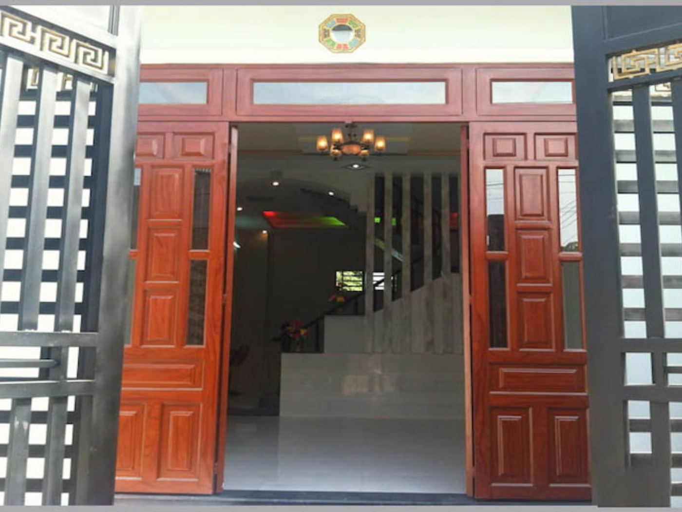 Treo gương bát quái giữa cửa đối cổng